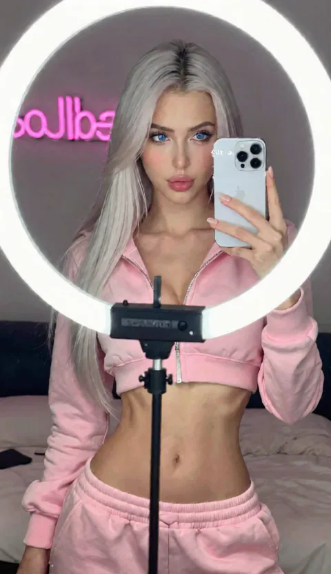 Bella — Content Creator, 21, platinum hair in ring-light glow